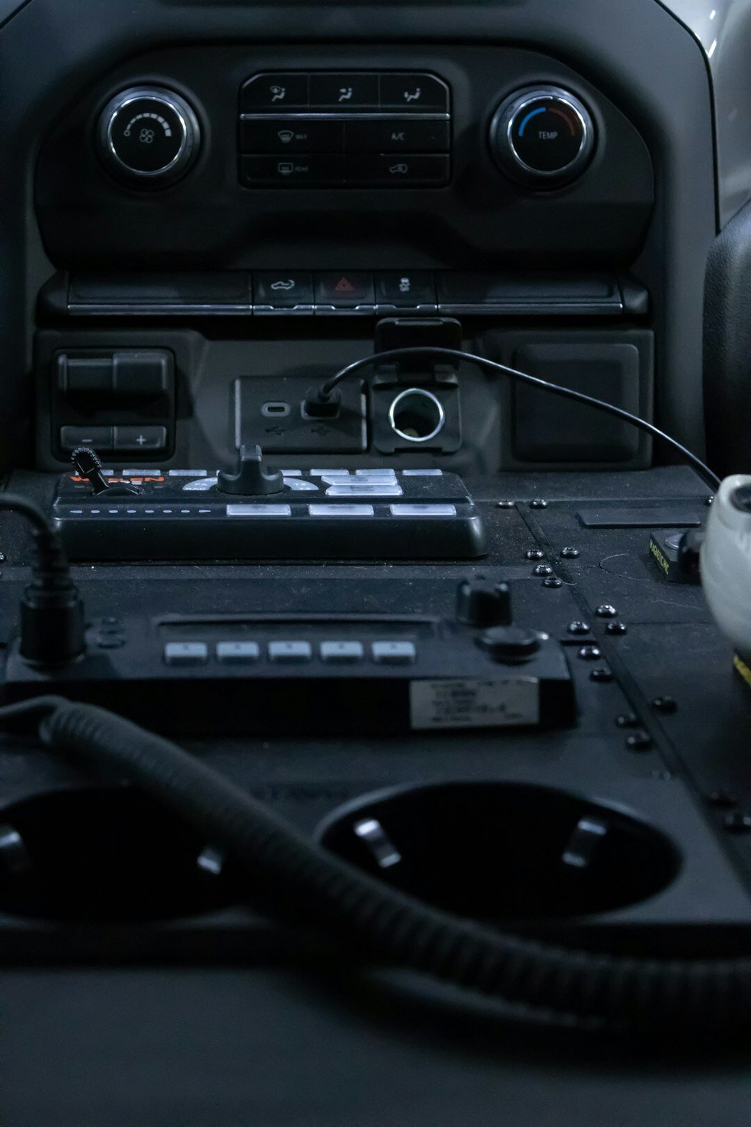 Interior of an outside broadcast van filled with monitors and cables